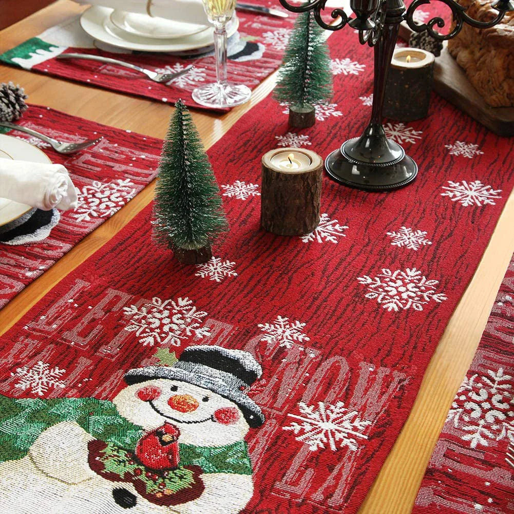 Red Christmas tablecloth with snowman and snowflake designs for festive holiday decor