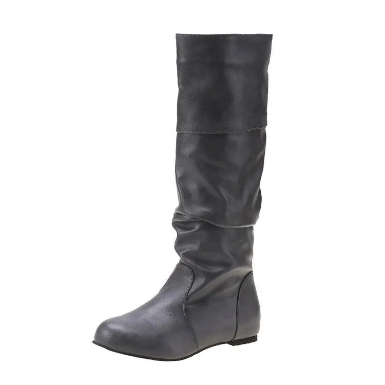 Women's flat slip-on boots in black with round toe and high cylinder shaft on a neutral background.