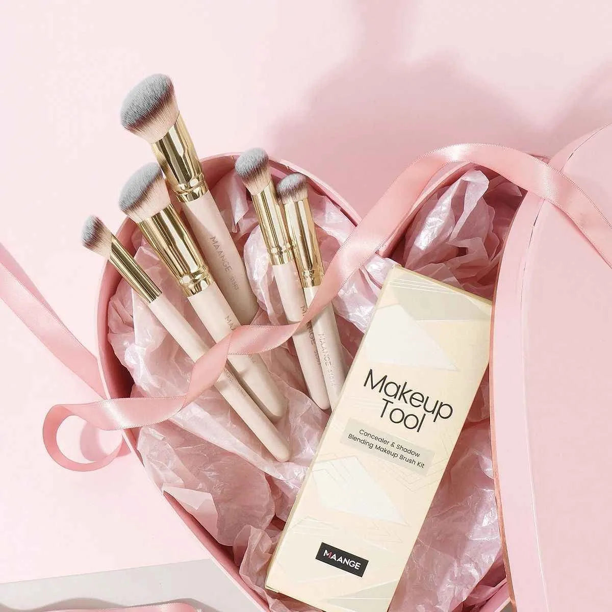 Apricot-coloured angled blush makeup brush and kabuki brush from a 5-piece synthetic bristle set.