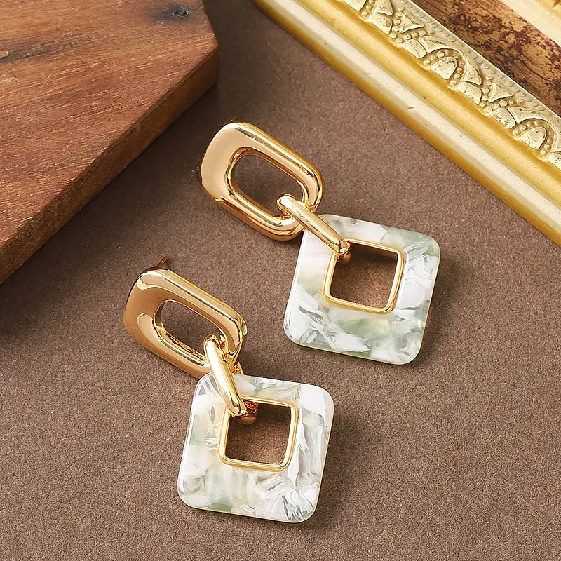 Hollow geometric square earrings with chamfered corners and electroplated copper finish