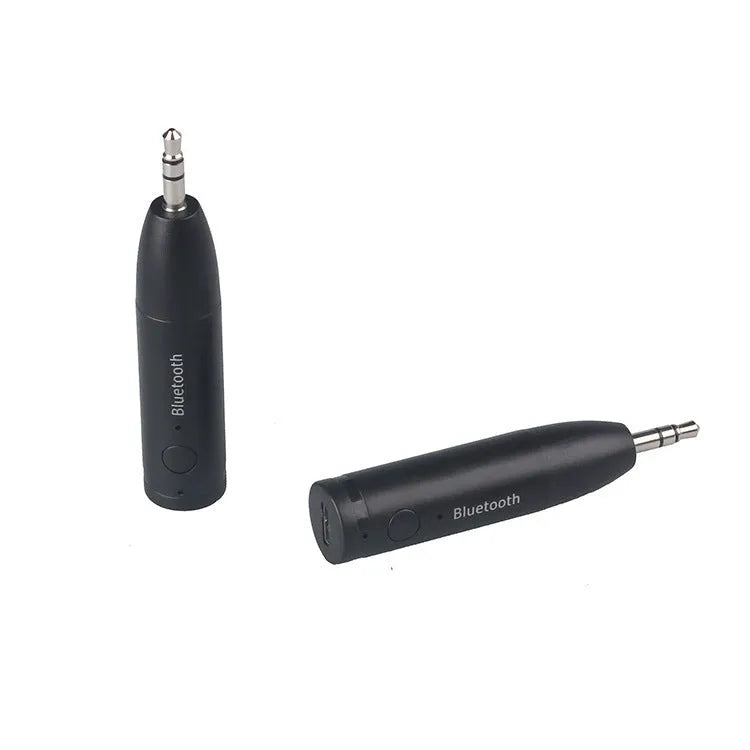 Compact black Bluetooth audio receiver with 3.5mm jack for car stereo and USB cable.