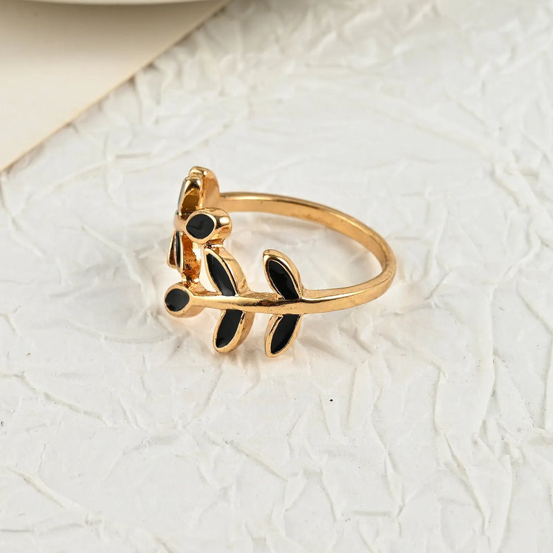 Geometric ring featuring leaf motif, gold electroplated brass base with acrylic accent for index finger wear, simple niche fashion jewellery for women with floral shape design.