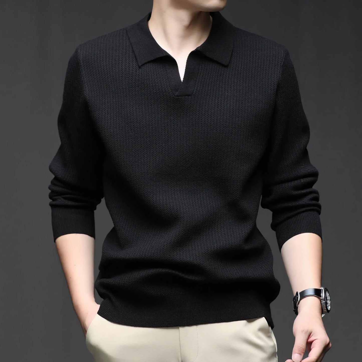 Man wearing a loose fit camel coloured pullover sweater, a casual autumn layer with a simple design.