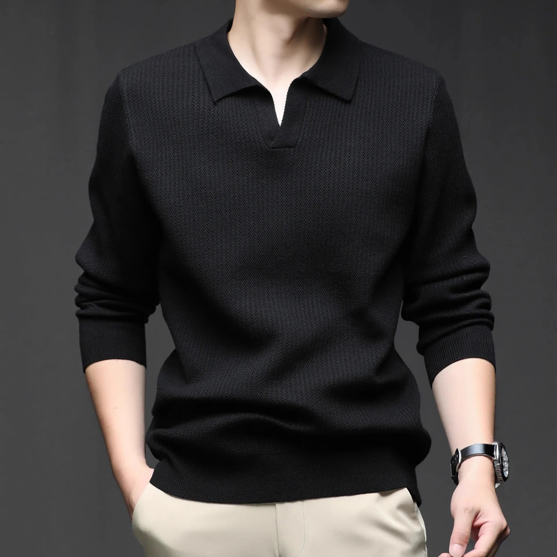 Man wearing a loose fit camel coloured pullover sweater, a casual autumn layer with a simple design.