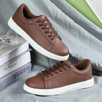 Beige brown women's low-top platform casual sneakers with a cross strap and round toe on a white background.