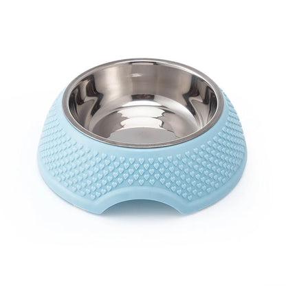 Blue stainless steel pet bowl with non-slip weighted base on a plain surface.