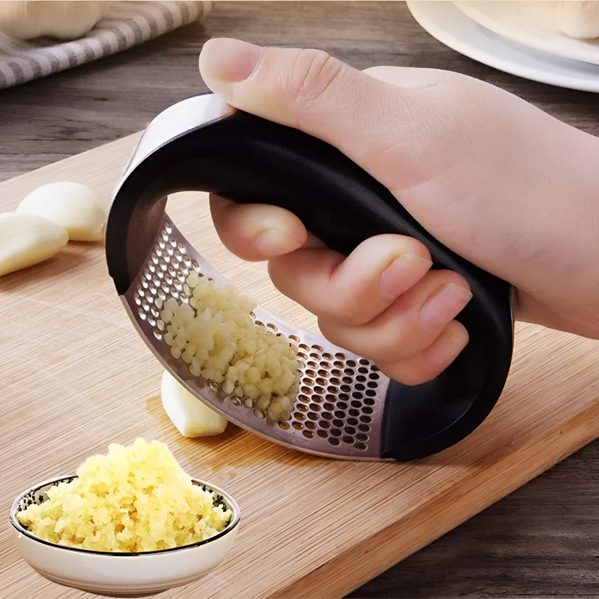 Stainless steel garlic press with ergonomic handle in kitchen setting