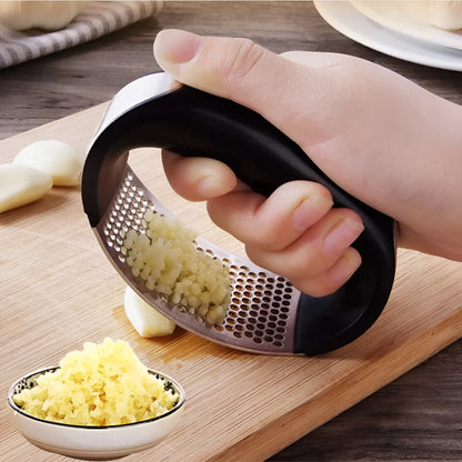 Stainless steel garlic press with ergonomic handle in kitchen setting