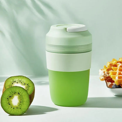 Green portable USB rechargeable blender cup with lid and four stainless steel blades, 400ml capacity.