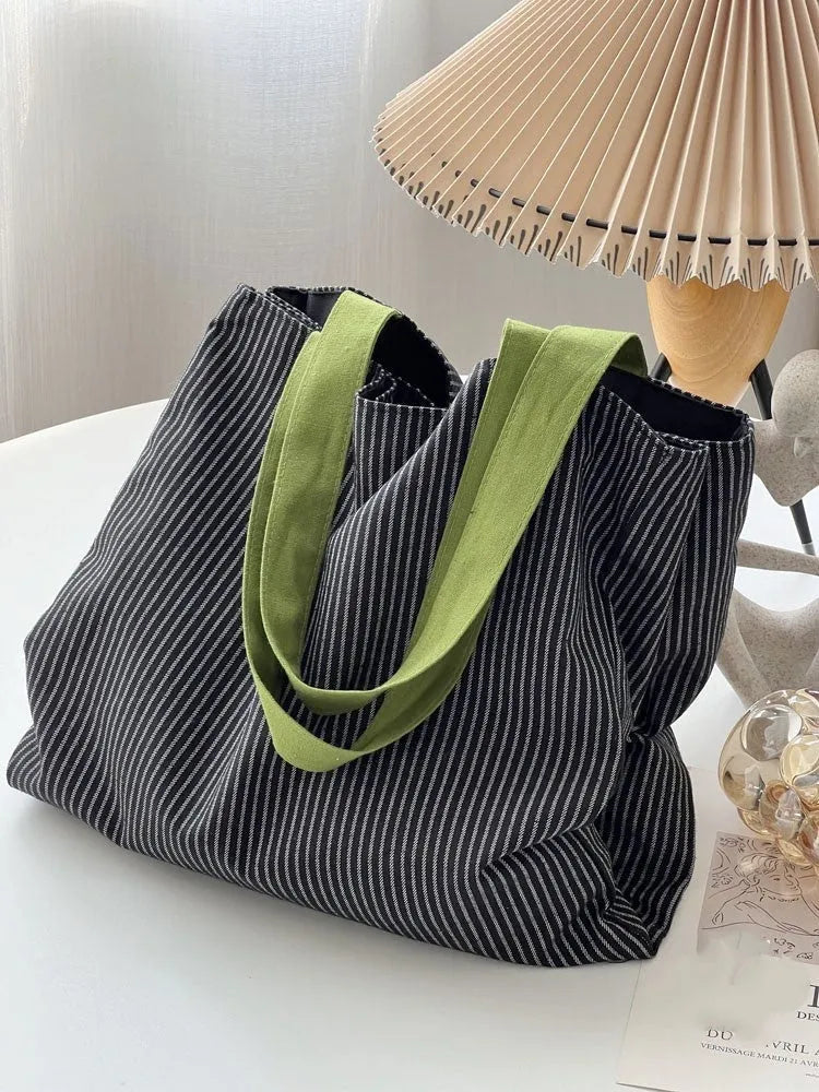 Light pink striped cotton canvas multi-layer tote bag with a wide shoulder strap.