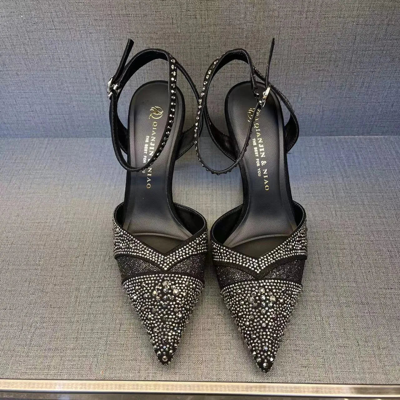 Women's hollow high heels with red sole, stiletto heel, and pointed toe in silver or black colours