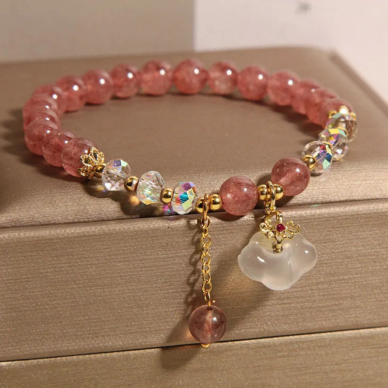 Women's adjustable crystal bracelet with strawberry quartz, white agate beads, and auspicious cloud charms