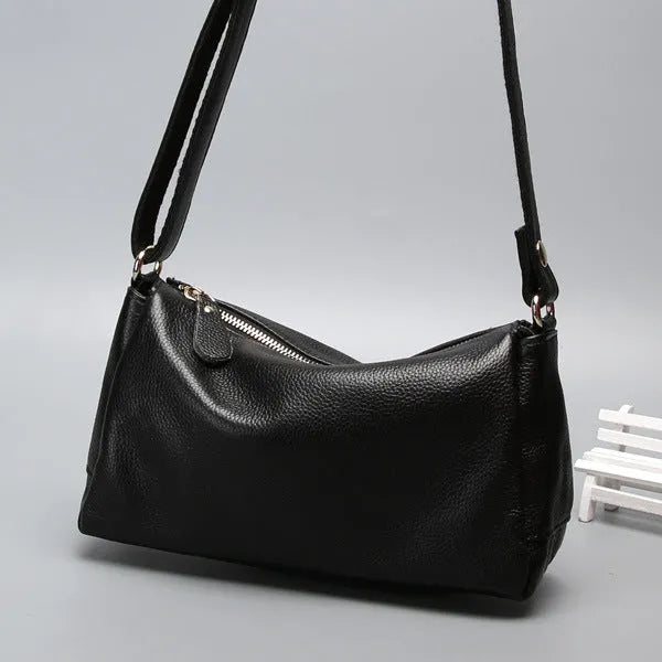 Soft genuine leather women's crossbody bag in horizontal square shape with single shoulder strap.