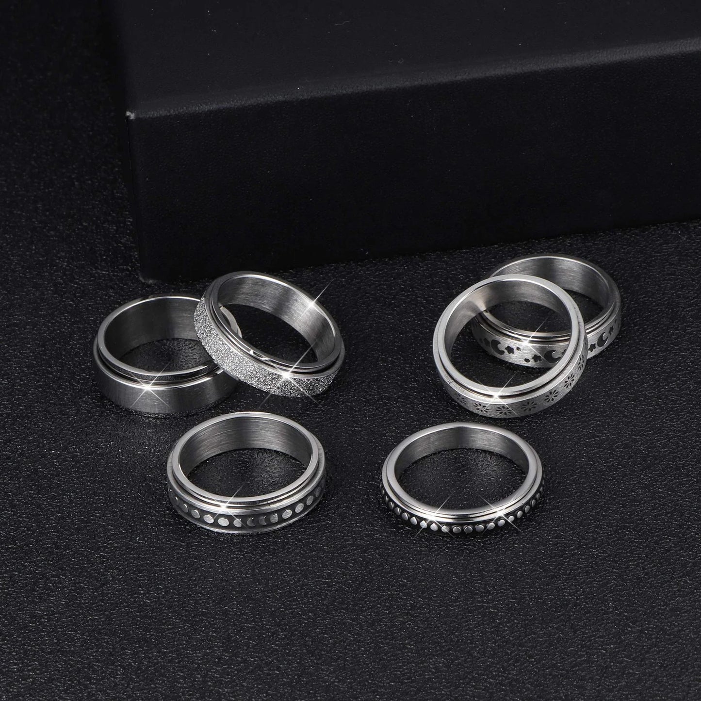 Stainless steel spinner ring with intricate moon and stars design