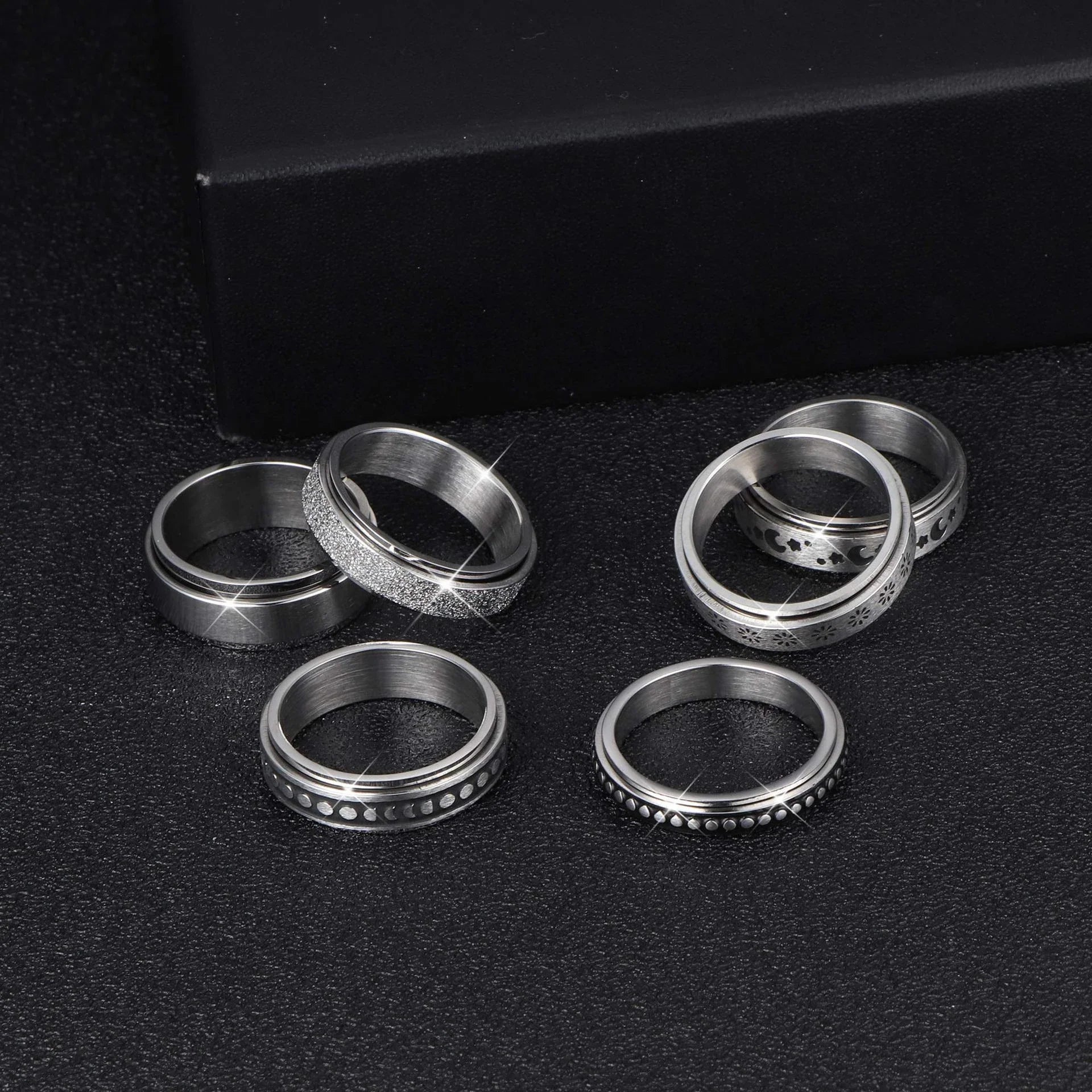 Stainless steel spinner ring with intricate moon and stars design