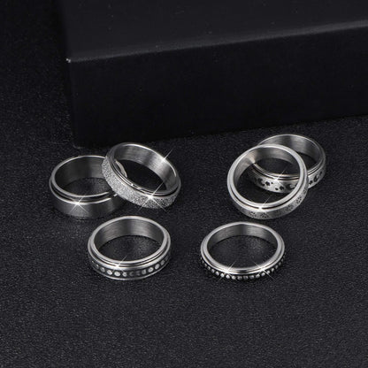 Stainless steel spinner ring with intricate moon and stars design