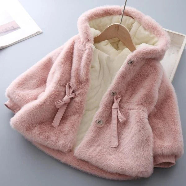 Baby wearing a cozy, velvet-padded wool coat in pink or beige color
