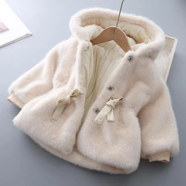 Baby wearing a cozy, velvet-padded wool coat in pink or beige color