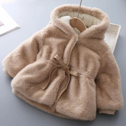Baby wearing a cozy, velvet-padded wool coat in pink or beige color