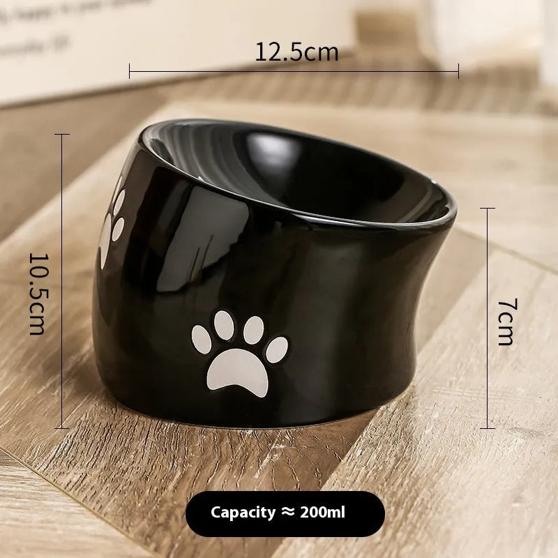 Ceramic cat bowl with high foot and cat's paw base in an oblique mouth design.