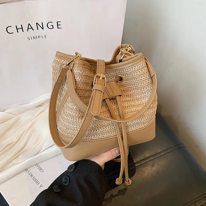 Woven straw women's crossbody bucket bag in brown colour with adjustable strap