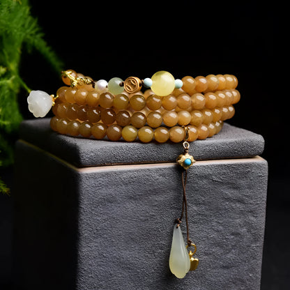 Women's bracelet with green pine beads, beeswax elements, leaf shapes, and sequin accents