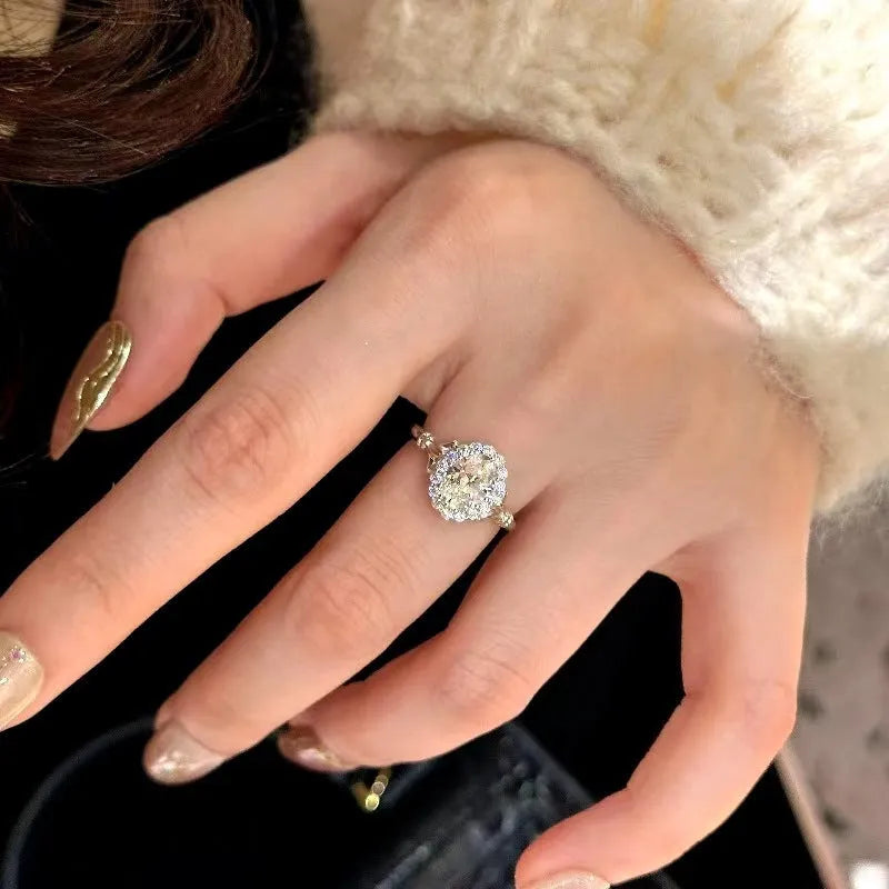 Silver colour geometric ellipse ring with adjustable opening and diamond-treated surface