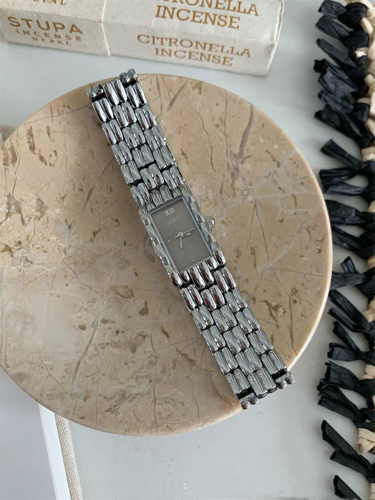 Bracelet-style women's watch with 15mm dial, 7mm thickness, mineral glass, and butterfly buckle in silver or gold.