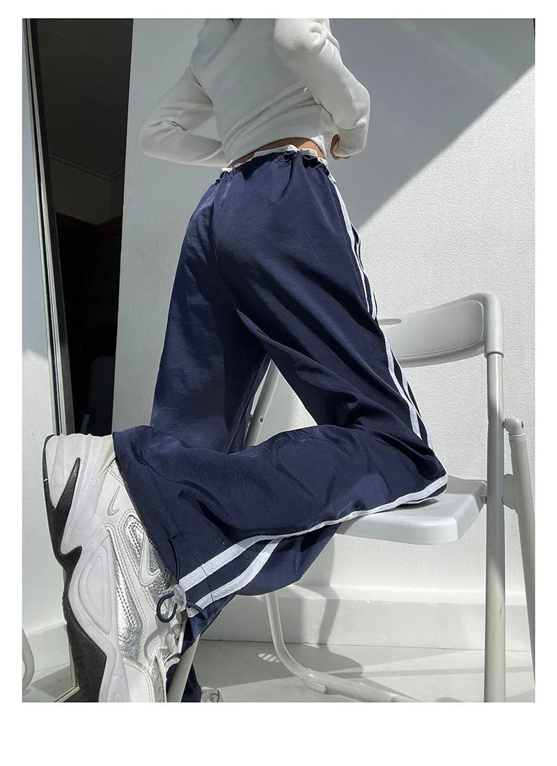 Women's loose straight leg trousers with ribbon parallel bars contrast colour detail on low waist, in thin fabric.