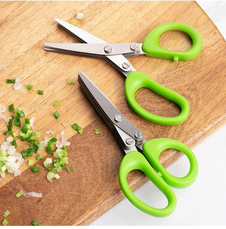 Green stainless steel multi-layer V-shaped kitchen scissors for cutting onions and herbs.