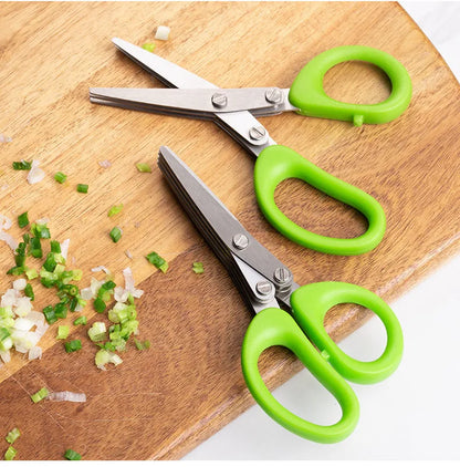 Green stainless steel multi-layer V-shaped kitchen scissors for cutting onions and herbs.