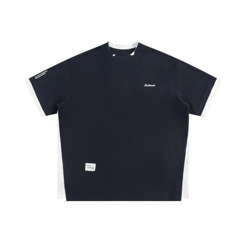Navy blue loose waffle knit T-shirt with retro white alphabet embroidery on the chest.
