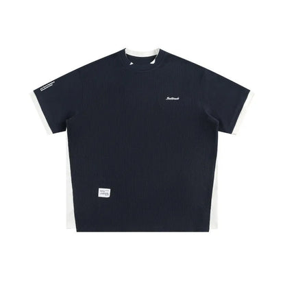 Navy blue loose waffle knit T-shirt with retro white alphabet embroidery on the chest.