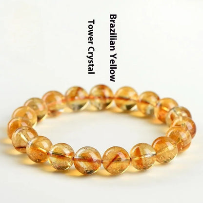 Natural yellow citrine bracelet with geometric beads in various sizes from 4mm to 20.8mm diameter on wrist