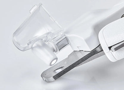 White pet nail clippers with LED light, anti-splash guard, and built-in nail file on a flat surface.