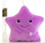 Colourful glowing five-pointed star plush pillow on a dark background.