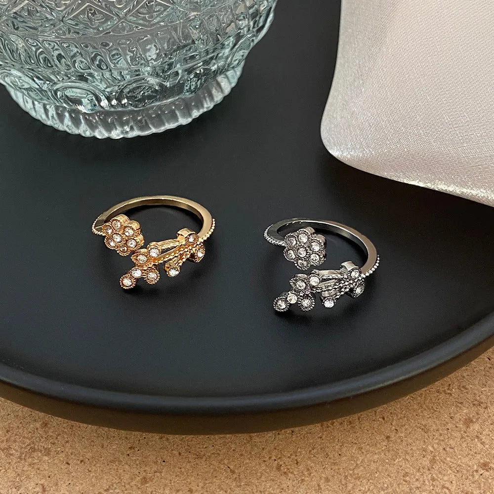 Women's copper open ring with diamond-treated flower and leaf design in gold colour.