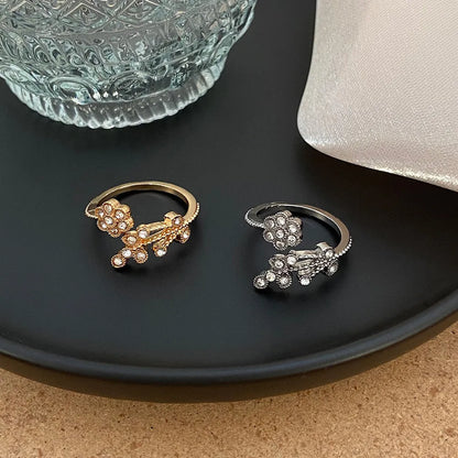 Women's copper open ring with diamond-treated flower and leaf design in gold colour.
