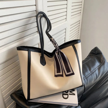 Soft PU shoulder tote bag in black with open outer pockets and internal organisation compartments