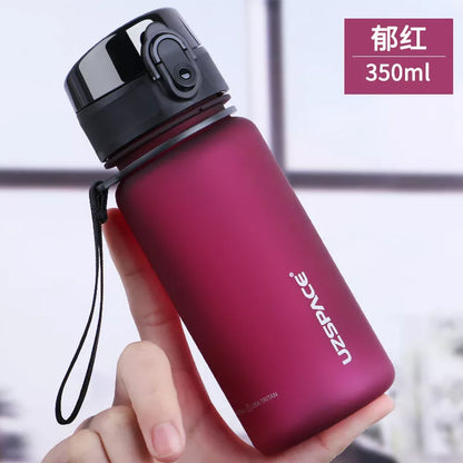 Large capacity Tritan sports water bottle in vibrant colors, perfect for hydration on the go