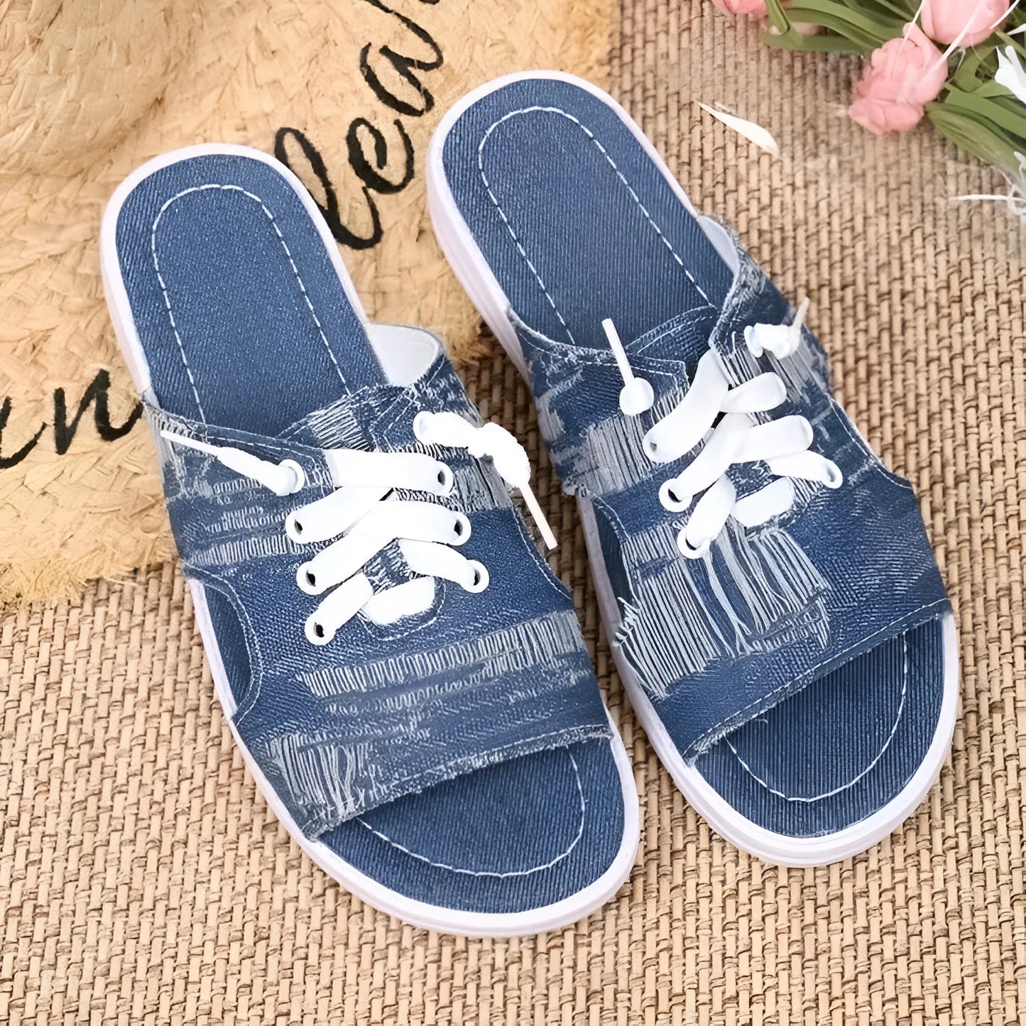 Blue Roman-style women's flat canvas slippers with a cloth upper and rubber sole.