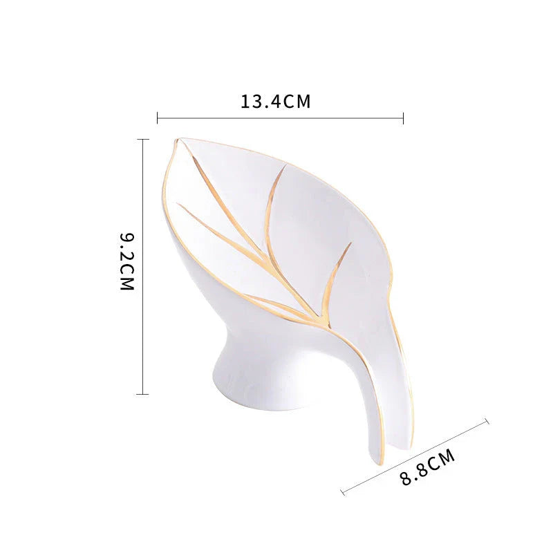 Elegant ceramic soap dish with leaf-shaped design, suction cup, and drainage holes for bathroom and kitchen use
