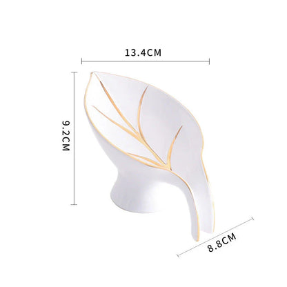 Elegant ceramic soap dish with leaf-shaped design, suction cup, and drainage holes for bathroom and kitchen use