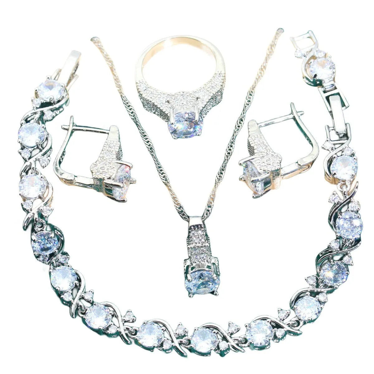Four-piece bridal jewellery set with zircon pendants on a water wave chain, showing necklace, bracelet, earrings and ring.