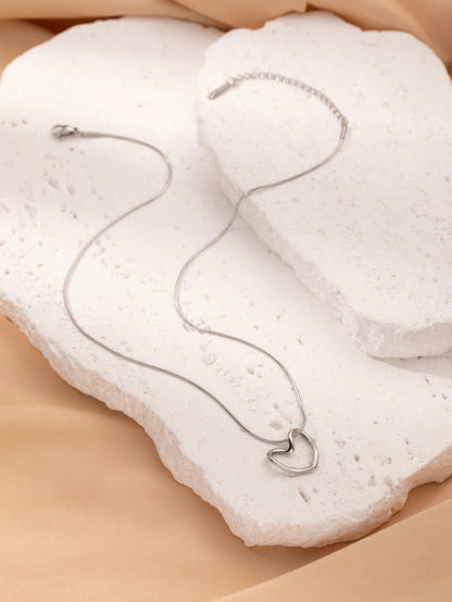 Stylish titanium steel heart pendant necklace with unique twist design, available in gold and silver colors