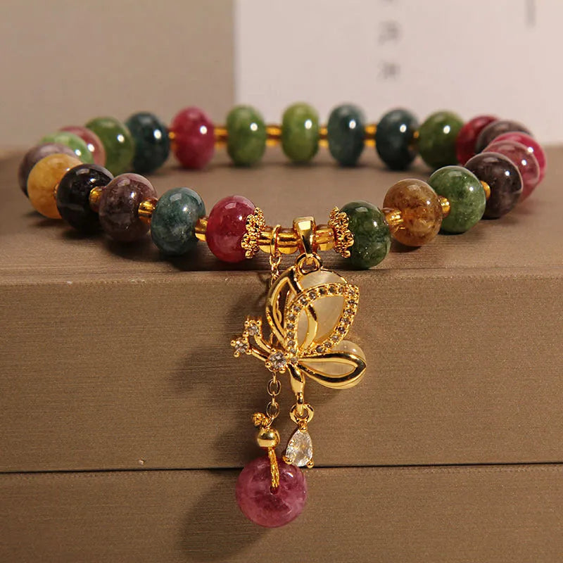 Colourful women's bracelet with butterfly charm, beads, and tourmaline accents on an alloy chain.