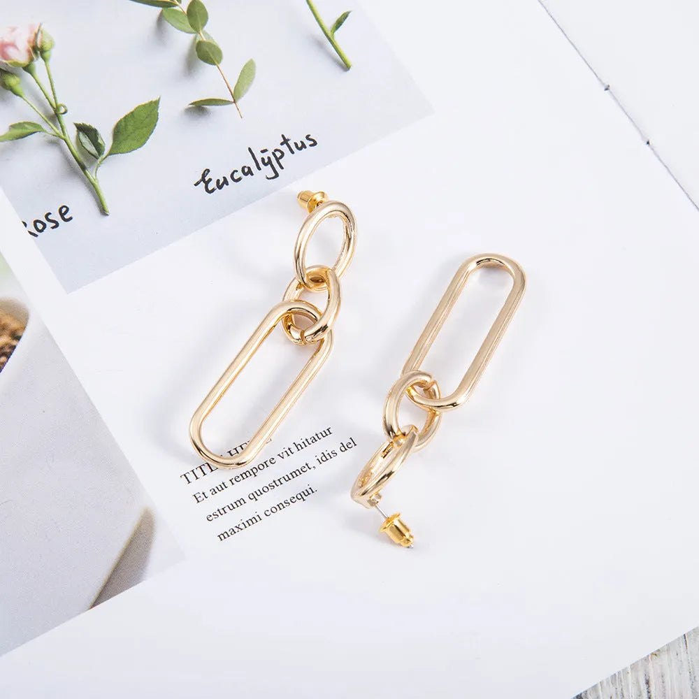 Geometric sterling silver needle finish hoop earrings showing ring and line design elements