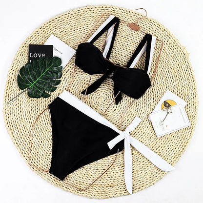 Black high-waisted bikini swimsuit set with stitching detail on a mannequin.