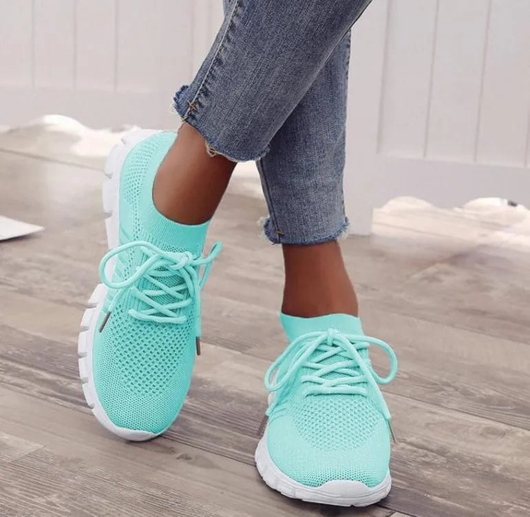 Women's lace-up platform sneaker in multiple colours with a low-top profile and rubber sole.