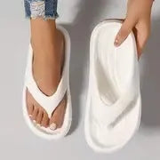Women's black thick-soled EVA flip-flops with a non-slip pattern on the sole.